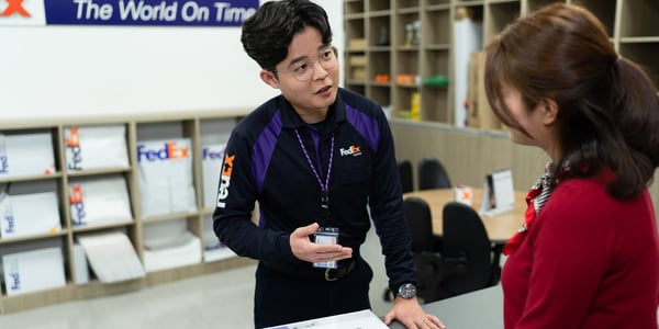 FedEx employee talking to customer