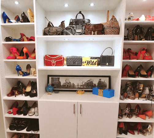 floor to ceiling shoe wall white closet with puck LED lighting and shelving to display purse collection in walk-in closet manhattan new york