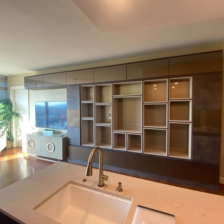 Richmond - Custom closets - Living room entertainment center covering the entire wall with cabinets and cubbies