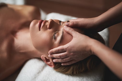 woman receiving head and face massage