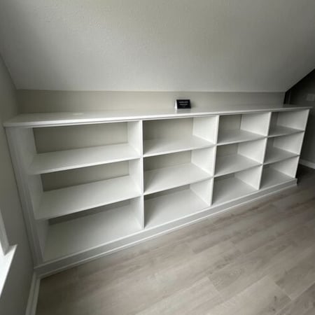 Virginia Beach - Custom closets - Custom built-in shelving under a sloped ceiling in a neutral room.