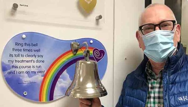 Peter ringing the bell to signal the end of treatment