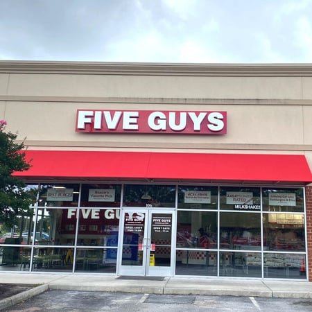 Exterior photograph of the entrance to the Five Guys restaurant at 4105 Chesapeake Square Boulevard in Chesapeake, Virginia.