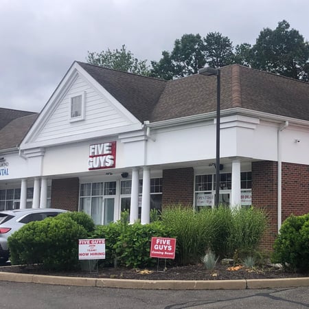 Exterior photograph of the Five Guys restaurant at 266-274 South Main Street in Newtown, Connecticut.