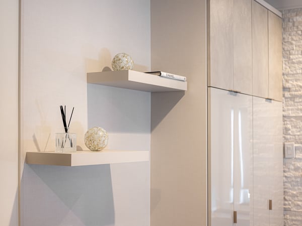 Wardrobe with leather, high-gloss doors, and shelves by California Closets Northern New Jersey.