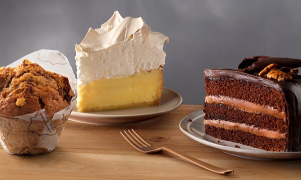 Slices of freshly baked lemon meringue, indulgent chocolate cake, and a generous giant muffin from Mugg & Bean