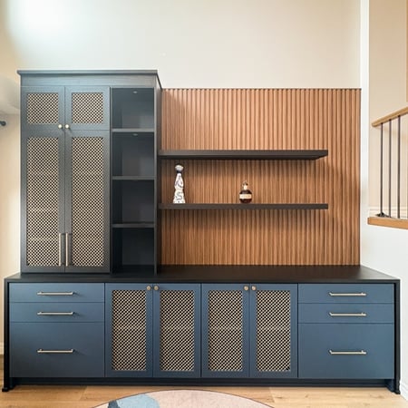 Home office in a gray finish with lower storage, open shelving, and lighting.