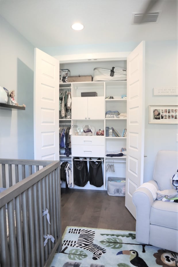 custom nursery closet in white with shelving and hanging by California Closets St. Petersburg, Florida.