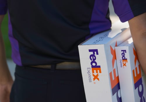 FedEx Express employee holding packages
