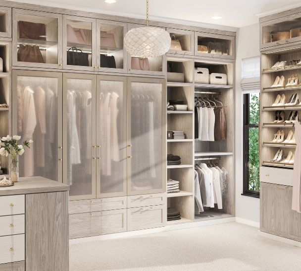 Custom Walk-In Closet Floor-to-Ceiling Cabinetry Glass Front Doors Hanging Sections Open Shelving Drawer Storage Shoe Storage Light Wood Finish by California Closets South Palm Beach Florida