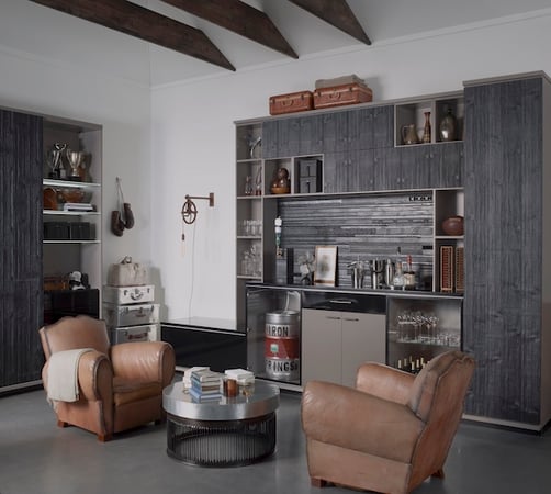 Garage cabinets with custom storage, glass shelving, built-in beverage fridge and bar area for an organized garage entertainment space. California Closets, Greater Detroit