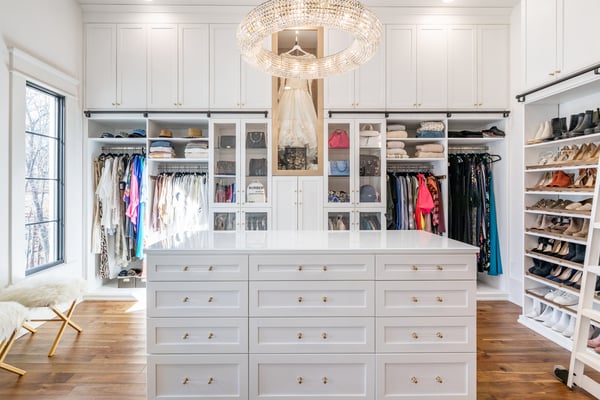 White walk-in closet with center island, clothing display, and custom shelving by California Closets Nashville, Tennessee.
