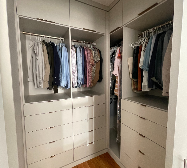 Img 6 California Closets Orange County New York Functional Walk-in Closet with Short Hanging for Shirts and Pants and Drawers Underneath in Beige with Gold Drawer Handles