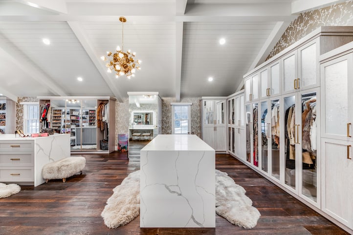 Large dressing room with two, quartz countertop, waterfall islands.