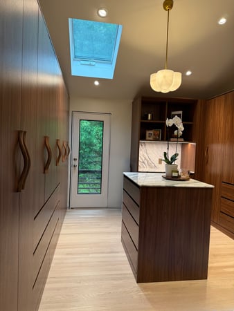 Warm Wood Custom Walk-in Closet with center island by California Closets Connecticut