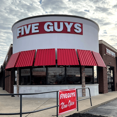 Exterior photograph of the Five Guys restaurant at 1401 S. Walton Boulevard in Bentonville, Arkansas.