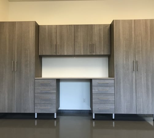 Grey garage and workbench with tall storage cabinets