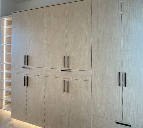 Walk-in closet with lit glass shelving by California Closets Pasadena.