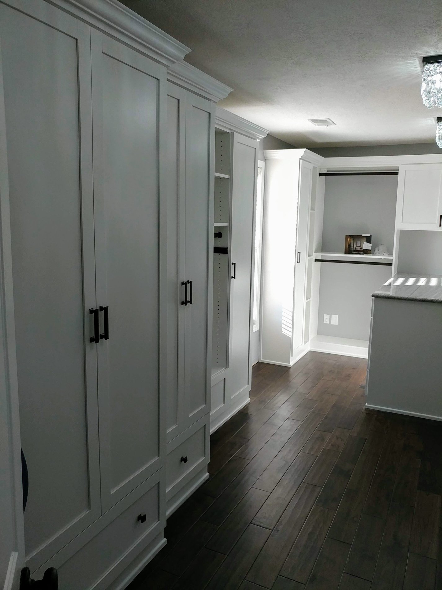 White walk-in closet with Floor-to-ceiling wardrobe doors.