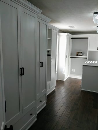 White walk-in closet with Floor-to-ceiling wardrobe doors.
