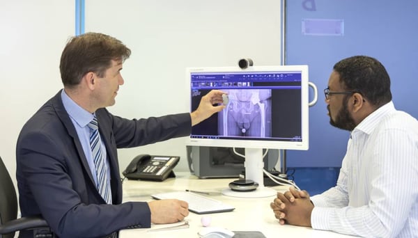 Hip surgeon in consultation with patient
