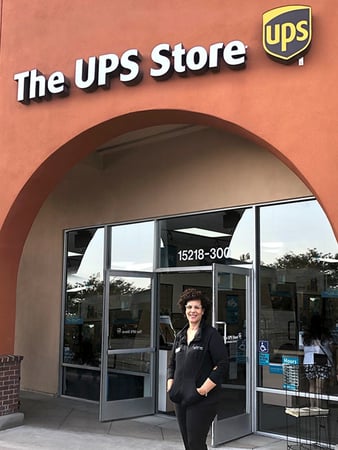 The UPS Store owner standing outside, in front of her store.