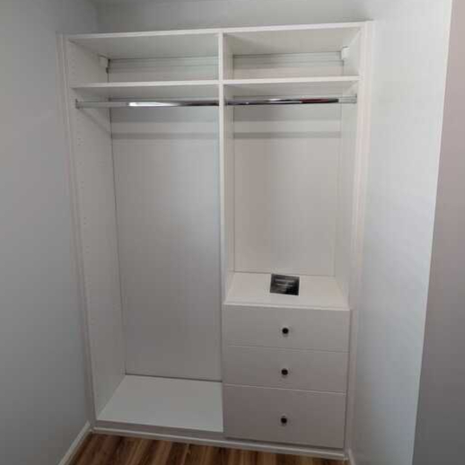 Virginia Beach - Custom closets - Reach-in closet with dual hanging rods and drawer tower on wood flooring.