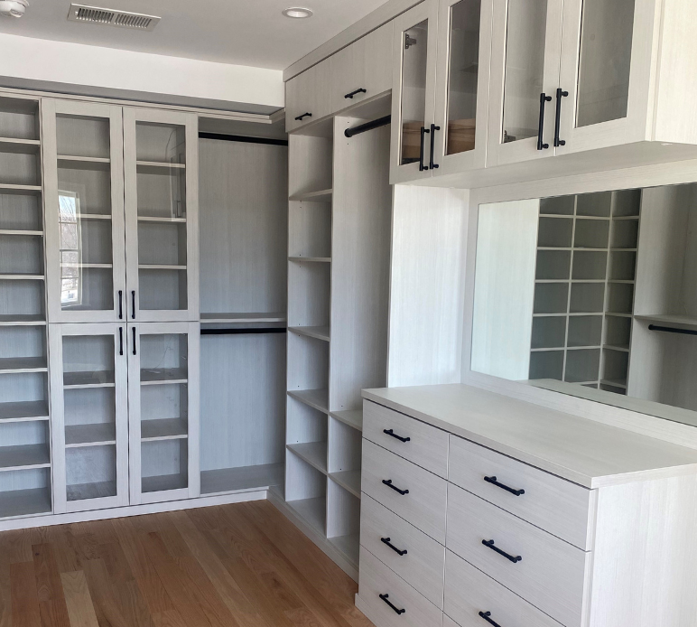 Img 1 - Full Room Walk in Closet in White with Black Hardware with Dresser Vanity with Mirror Hanging and Shelving Storage
