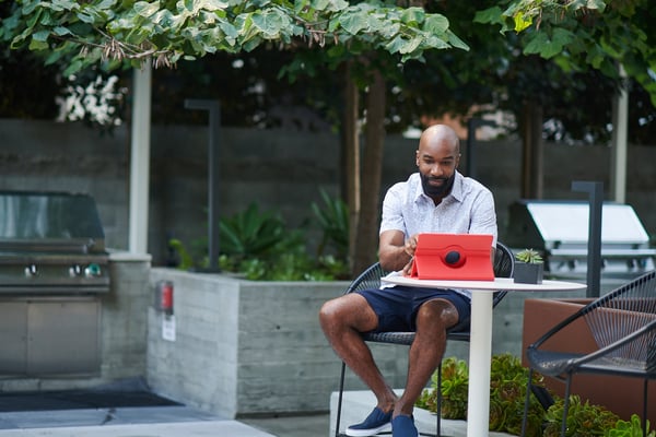 Man on laptop looking near BBQ looking for waste collection services