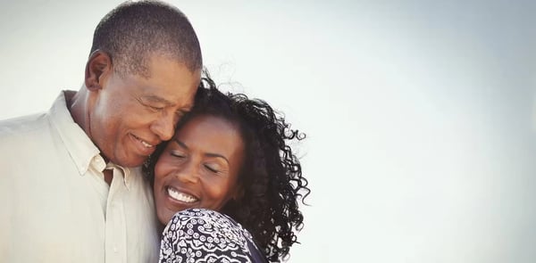 A middle-aged couple getting used to their hearing aids.