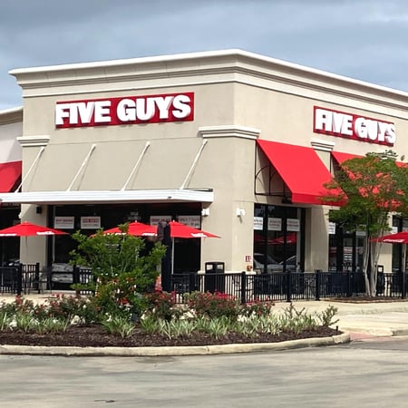 Exterior photograph of the Five Guys restaurant at 7415 Corporate Blvd. in Baton Rouge, Louisiana.