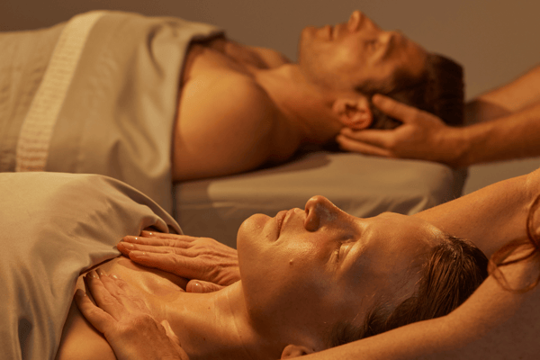 Couple enjoying a relaxing Woodhouse massage together in a duet massage suite.