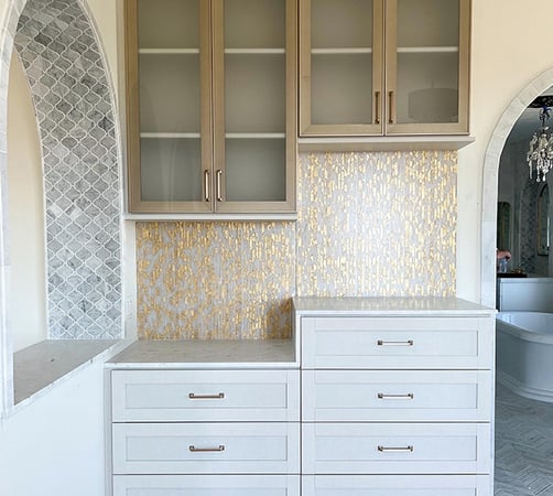 Small space storage with built in drawers, custom cabinets and unique wall covering by California Closets Orange County