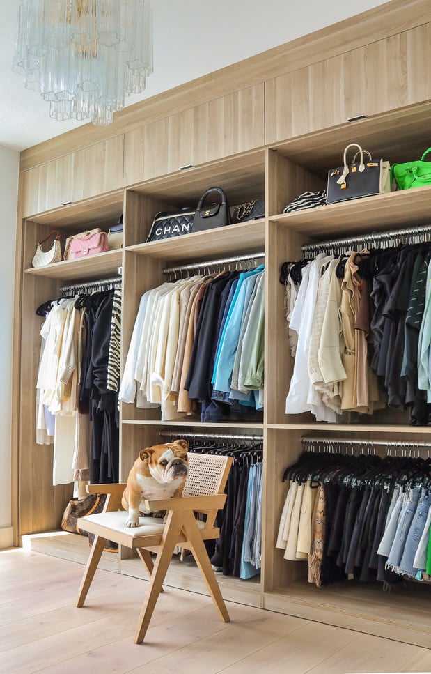 Custom Walk in Closet with tons of hanging room and upper cabinets by California Closets Miami, Florida.