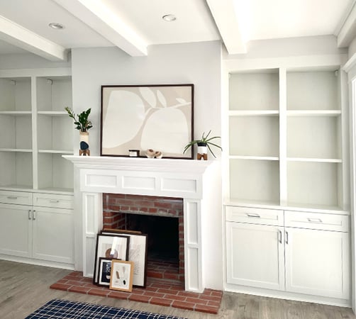 Family room custom cabinets and open shelving in a traditional white wood finish created by California Closets Pasadena