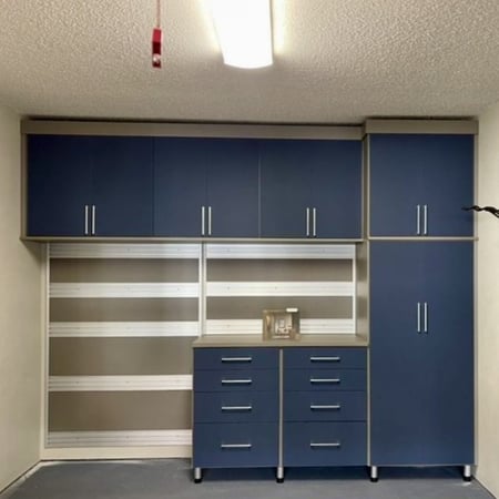 Matte blue cabinets for garage storage with fusion-track wall California Closets New Orleans & Gulf Coast, LA