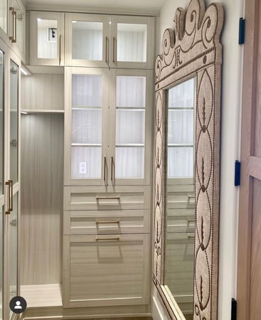 Tan grey walk-in closet shelves with organized clothes and accessories