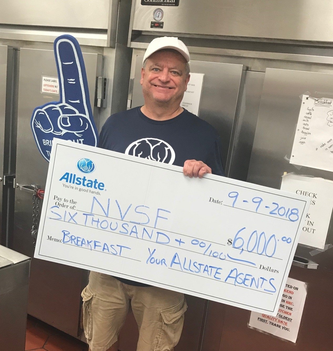 Michael Angles, Chantilly Virginia Allstate car insurance agent, holding donation check for Northern Virginia Family Services