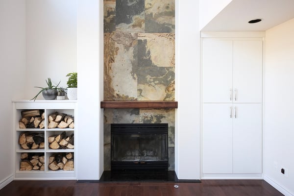 Functional living room storage for firewood one one side and toys and household items on the other.