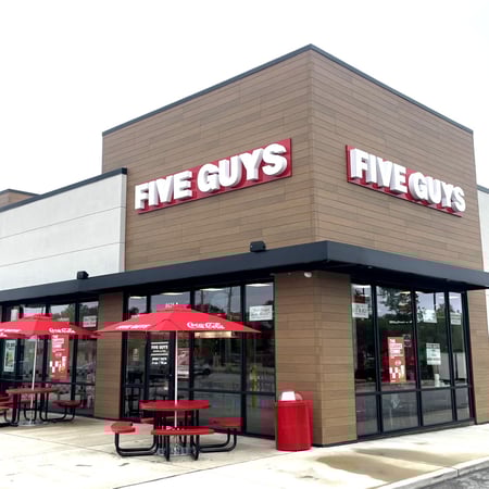 An exterior photograph of the Five Guys restaurant at 8628 Olive Boulevard in University City, Missouri.