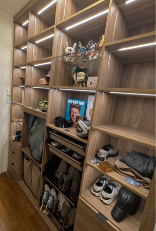 California Closets Nassau County Long Island NY Custom Natural Wood walk in closet with LED strip lighting shelving for accessories and personal items, glass shelving, custom pants drawer organizer
