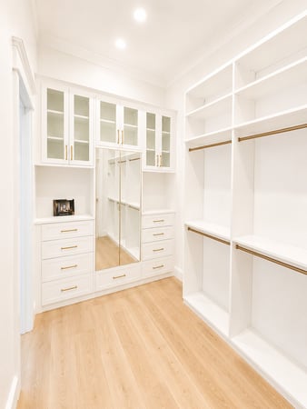 Custom closet with plenty of room for hanging clothes, drawers and mirror.