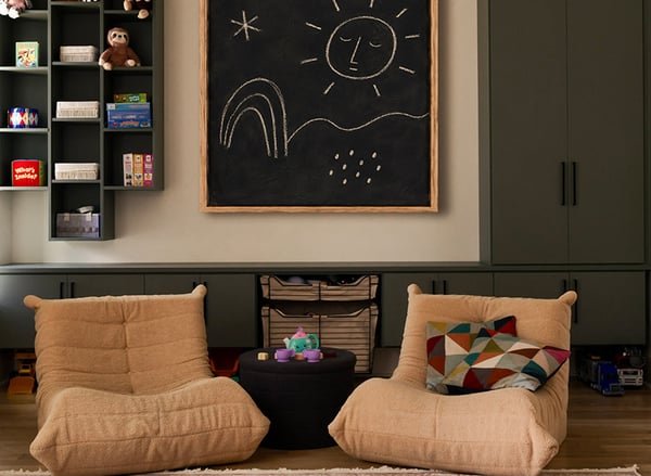 Custom kids' playroom storage with built-in cabinetry, open shelving and toy organization by California Closets Nashville.