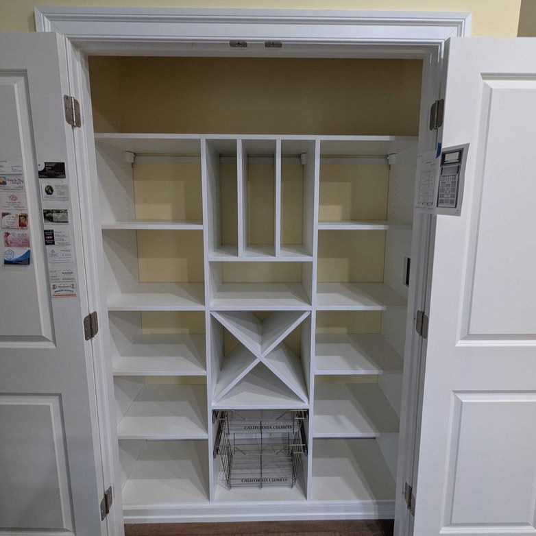 Richmond - Custom closets - white closet storage system behind double doors with shelving and baskets