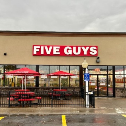 Exterior photograph of the entrance to the Five Guys restaurant at 1290 Arsenal Road in Watertown, New York.