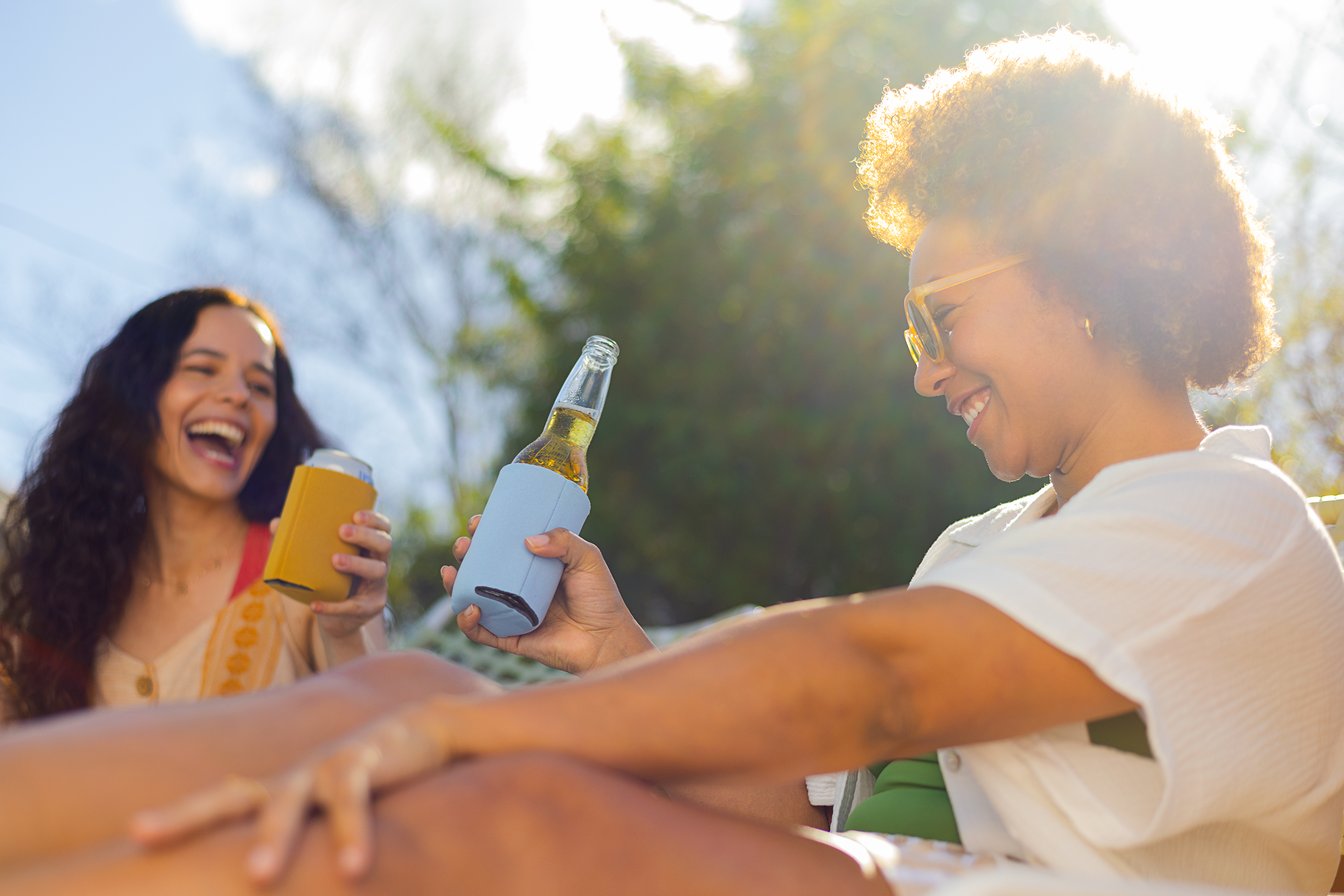 two women having drinks in the summer sun