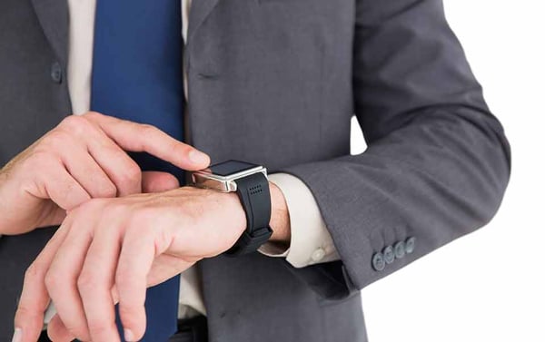 Person looking at his wearable smart watch at the workplace