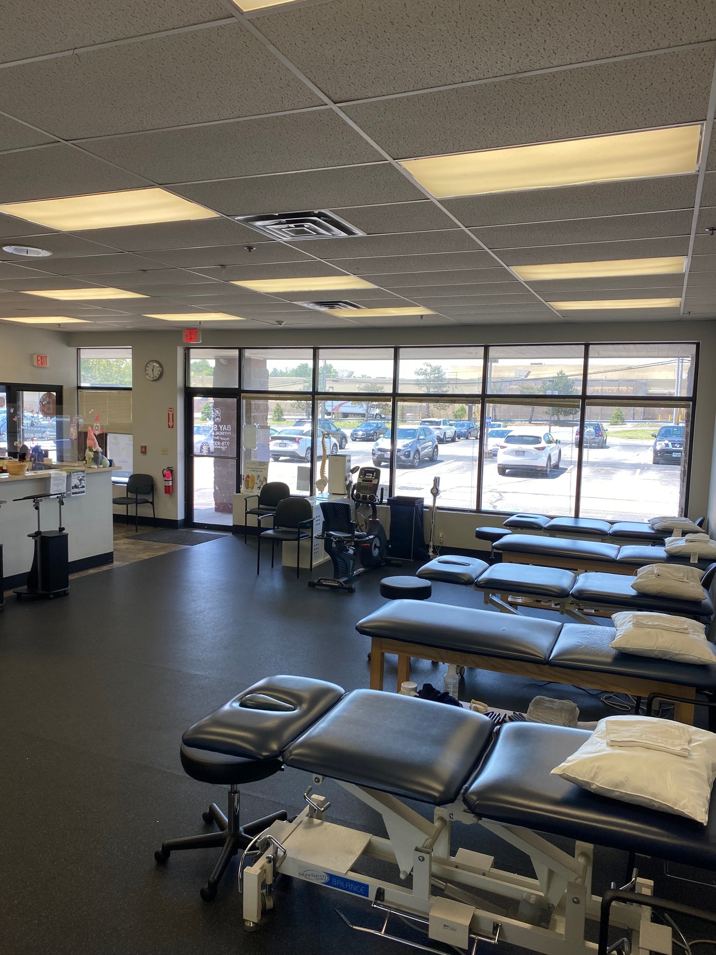 Inside Bay State Physical Therapy Chelmsford, MA Parkhurst St. showing PT patient tables in the background.
