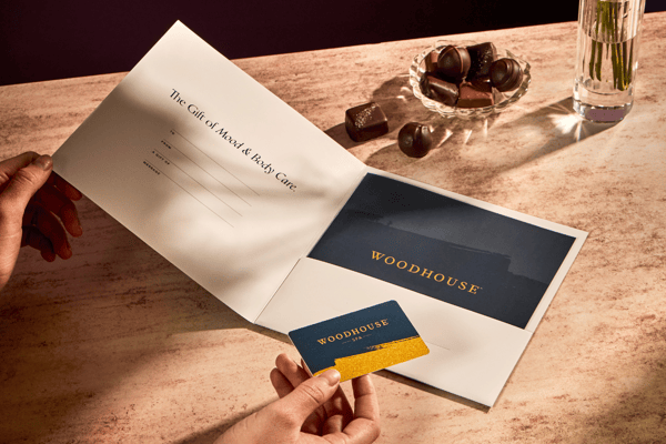 The Woodhouse Gift Card presented in a gift sleeve with spa menu.