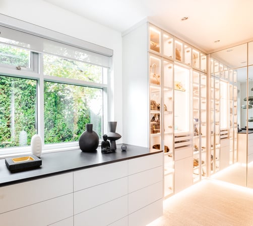 large walk in closet with counter space and built in lighting by California Closets Vancouver, British Columbia.